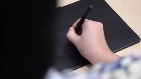 A designer draws on an electronic tablet Stock Footage 189514987