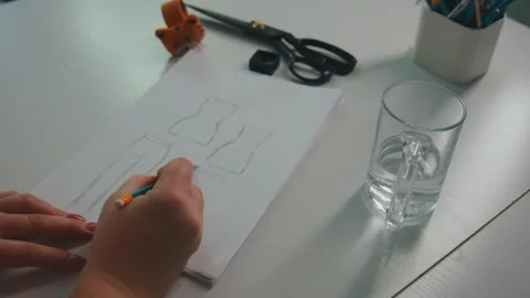Designer draws garment patterns on paper with tools around 스톡 동영상 348191369