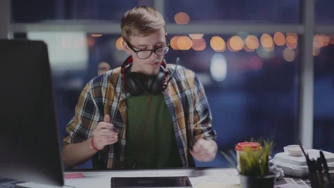 Designer draws in late evening, using a graphic tablet. Stock Footage 87160788