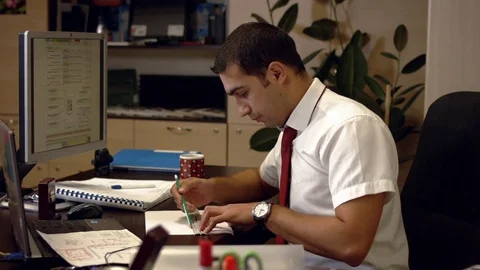 Designer draws something on paper when someone calls by phone Video stock 73363359