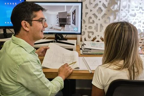 Designer explains to his client the plans of his new work Stock Photos