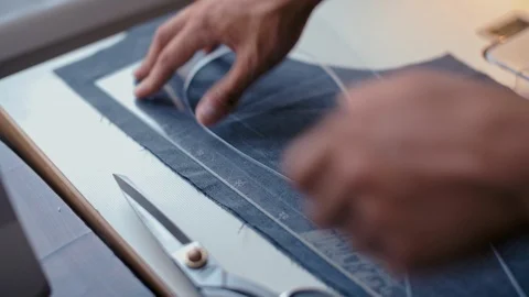 Designer Hands Making a Pattern on the Fabric before Sew Fashionable Clothes Stock Footage 90471579