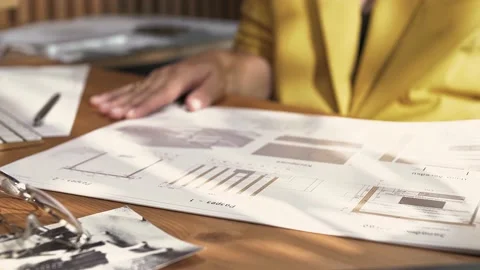 Designer at his workplace in the office opens the architectural plan Stock Footage 223101405