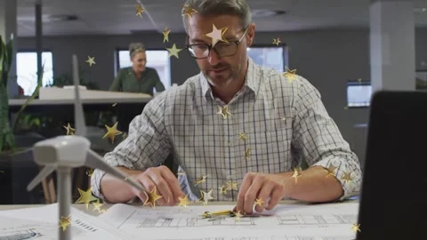 Designer leaning reaching aligning plans for turbine as woman watching gold Stock Footage 332404795