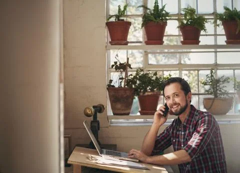 Designer looking up at the camera while on phone Stock Photos