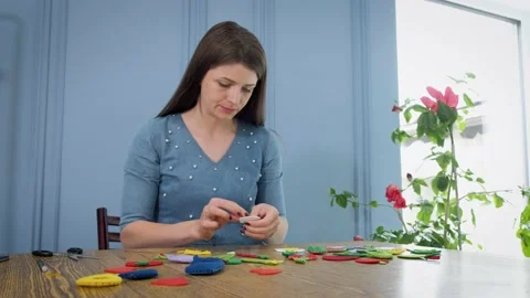 Designer makes, sews soft childrens toys from fabric. In the form of fruits  Stock Footage 131065800