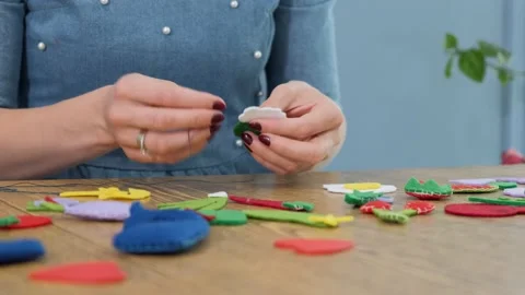 Designer makes, sews soft childrens toys from fabric. In the form of fruits Stock Footage 131066759