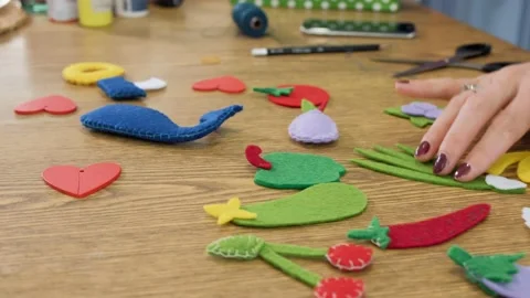 Designer makes, sews soft childrens toys from fabric. In the form of fruits Stock Footage 131066787