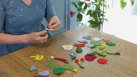 Designer makes, sews soft childrens toys from fabric. In the form of fruits Stock Footage 131066796