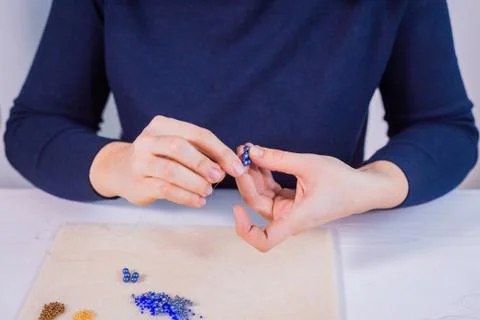 Designer making handmade eardrop Stock Photos