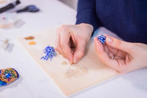 Designer making handmade eardrop Stock Photos