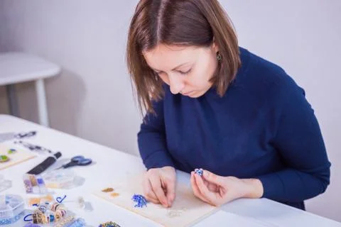 Designer making handmade eardrop Stock Photos