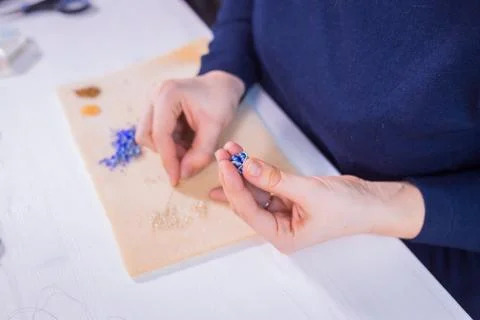 Designer making handmade eardrop Stock Photos