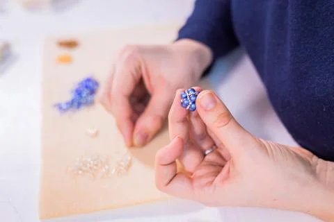 Designer making handmade eardrop Stock Photos