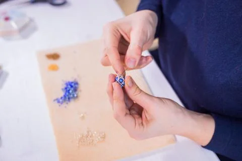 Designer making handmade eardrop Stock Photos