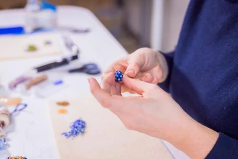 Designer making handmade eardrop Stock Photos