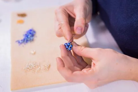 Designer making handmade eardrop Stock Photos