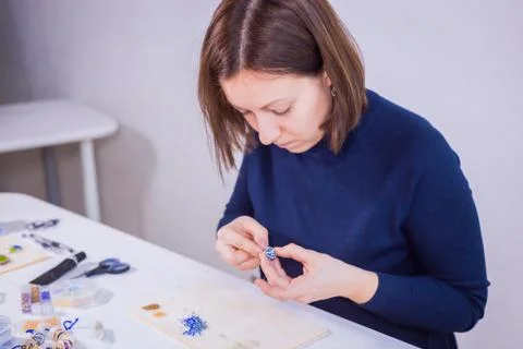 Designer making handmade eardrop Stock Photos