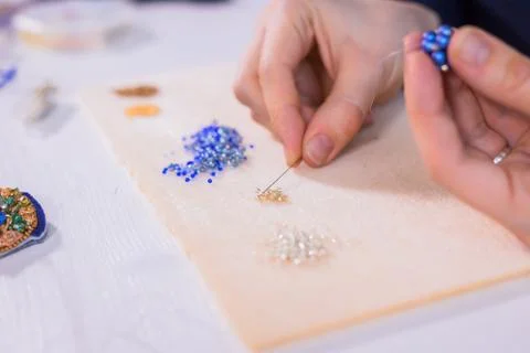 Designer making handmade eardrop Stock Photos