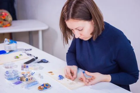 Designer making handmade eardrop Stock Photos
