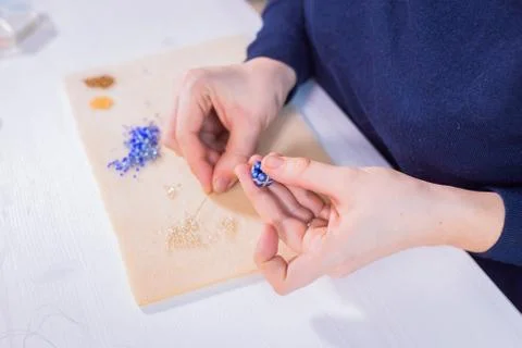 Designer making handmade eardrop Stock Photos