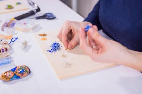 Designer making handmade eardrop Stock Photos