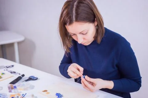 Designer making handmade eardrop Stock Photos