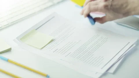 Designer is Marking Text in Document with Highlighter. Stock Footage 47251077