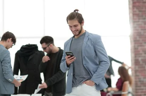 Designer with mobile phone on background creative Studio Stock Photos
