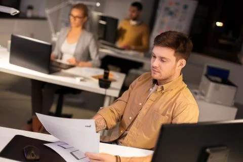 Designer or software developer at night office 스톡 사진