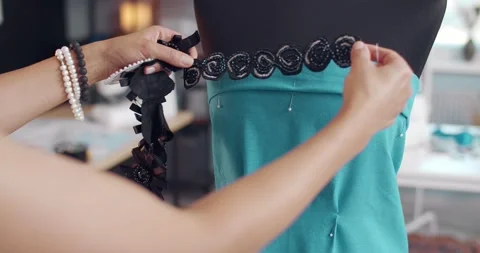 Designer picking up decorative elements for blue dress Video stock 135777761