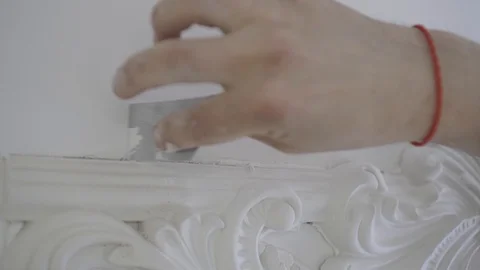 The designer removes excess material in the formation of white stucco Stock Footage 108948671