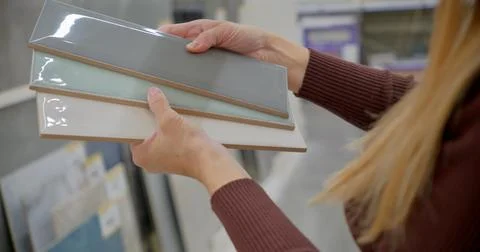 Designer Selecting Ceramic Tiles for Interior Design in Store Фото