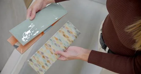 Designer Selecting Ceramic Tiles for Interior Design in Store 写真素材