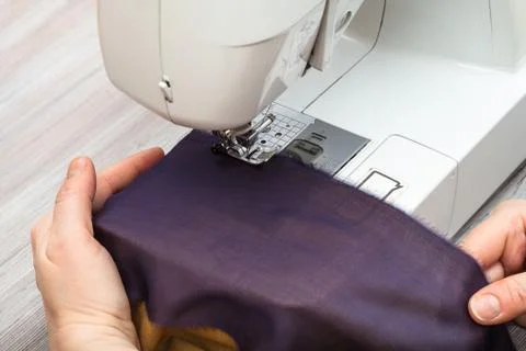 Designer sews bands of fabrics for patchwork Stock Photos