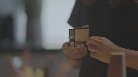 Designer showcasing a tiny 3D-printed or handmade chair model. Vídeo Stock 330239648