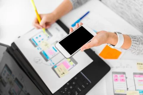 Designer with smartphone working on user interface 스톡 사진
