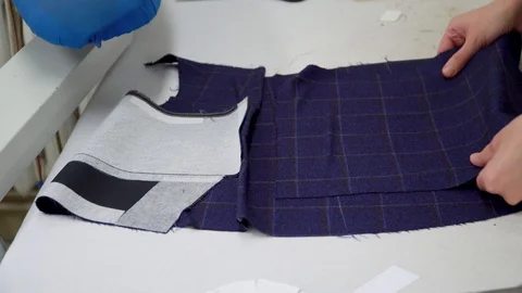 Designer tailor at work, collecting the product from the cut parts. Stock Footage 119513681