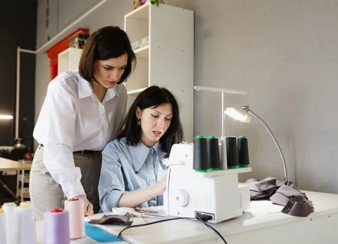 The designer teaches the student the correct tailoring . The concept of creat Stock Photos