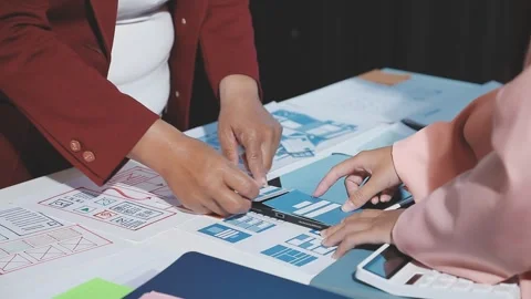 The designer team is designing the uxui system to make the uxui system work.. Stock Footage 290953233