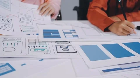 The designer team is designing the uxui system to make the uxui system work.. Stock Footage 308982641