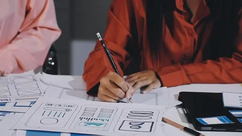The designer team is designing the uxui system to make the uxui system work.. Stock Footage 308982642