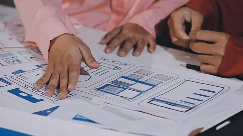 The designer team is designing the uxui system to make the uxui system work.. Stock Footage 308982652