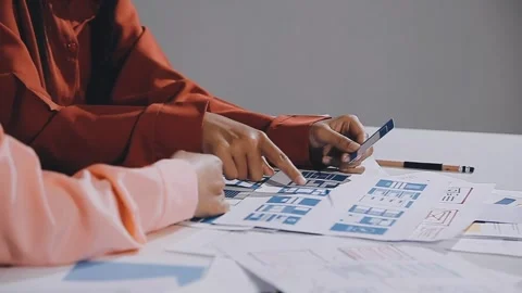 The designer team is designing the uxui system to make the uxui system work.. Stock Footage 308982698