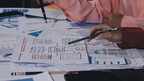 The designer team is designing the uxui system to make the uxui system work.. Stock Footage 308982706