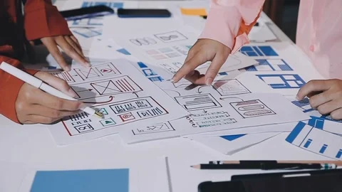 The designer team is designing the uxui system to make the uxui system work.. Stock Footage 308982716