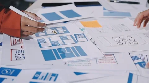 The designer team is designing the uxui system to make the uxui system work.. Stock Footage 308982727