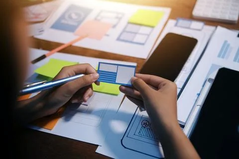 The designer team is designing the uxui system to make the uxui system work.. Stock-Fotos