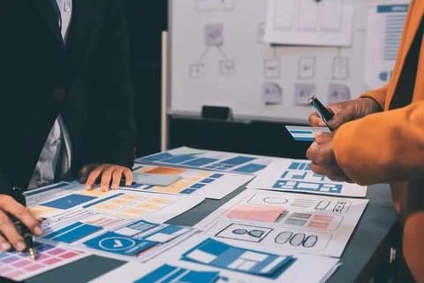The designer team is designing the uxui system to make the uxui system work.. Stock-Fotos