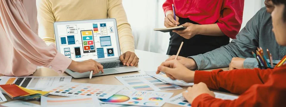 Designer team present color while laptop displayed UI and UX designs Variegated. Foto stock